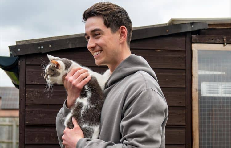man carrying a rescue cat